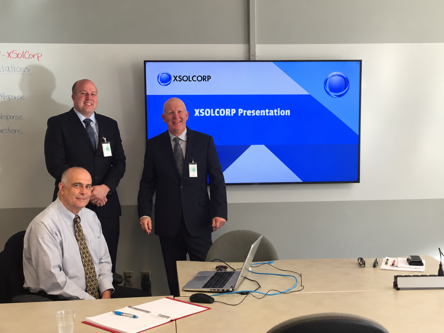 XSOLCORP colleagues together at an onsite presentation